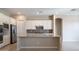 Spacious kitchen featuring an island with seating, stainless steel appliances, and tile flooring at 4323 E Wheaton St, Gilbert, AZ 85295