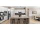 Open-concept kitchen with stainless steel appliances, island with seating, and ample cabinet space at 4323 E Wheaton St, Gilbert, AZ 85295