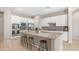 Well-lit kitchen with a large island, white cabinets, and stainless steel appliances at 4323 E Wheaton St, Gilbert, AZ 85295