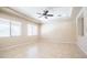 Bright living room with ample natural light, tiled flooring, ceiling fan, and neutral paint, offering a serene atmosphere at 4323 E Wheaton St, Gilbert, AZ 85295