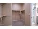 Well-organized walk-in closet with shelving, rods, and ample space at 4323 E Wheaton St, Gilbert, AZ 85295