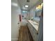 Bright bathroom featuring dual sinks, illuminated mirror, and neutral decor at 4902 W Vista Ave, Glendale, AZ 85301