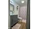 Updated bathroom featuring a stylish vanity, decorative mirror, shower, and modern finishes at 4902 W Vista Ave, Glendale, AZ 85301