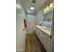 Bright bathroom featuring dual sinks, illuminated mirror, and neutral decor at 4902 W Vista Ave, Glendale, AZ 85301