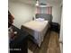 Cozy bedroom with light wood floors, ceiling fan and comfortable looking bed at 4902 W Vista Ave, Glendale, AZ 85301