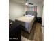 Cozy bedroom with light wood floors, ceiling fan and comfortable looking bed at 4902 W Vista Ave, Glendale, AZ 85301