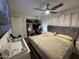Comfortable bedroom with a plush queen bed, ceiling fan, and open closet space for plenty of storage at 4902 W Vista Ave, Glendale, AZ 85301