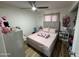 Bedroom featuring light colored walls, ceiling fan, and comfortable looking bed at 4902 W Vista Ave, Glendale, AZ 85301