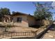 View of the exterior displaying a brick home, fence, and spacious yard at 4902 W Vista Ave, Glendale, AZ 85301