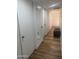 Hallway featuring wood floors, neutral colored walls and multiple doors at 4902 W Vista Ave, Glendale, AZ 85301