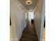 Bright hallway featuring wood-look floors, white walls, and recessed lighting, leading to a white paneled door at 4902 W Vista Ave, Glendale, AZ 85301