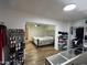 Bedroom with modern flooring, walk-in closet, tufted headboard, and good lighting at 4902 W Vista Ave, Glendale, AZ 85301