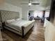 Bedroom featuring modern flooring, walk-in closet, tufted headboard, and good lighting at 4902 W Vista Ave, Glendale, AZ 85301