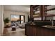 Contemporary bar area with wooden cabinets, sleek countertops, and stylish lighting at 4915 N Ascent Dr, Scottsdale, AZ 85251
