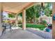 Covered patio with lush backyard, mature trees, and landscaped yard at 514 E Yvonne Ln, Tempe, AZ 85284