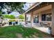 Spacious backyard features a covered patio, string lights, and view of the pool at 514 E Yvonne Ln, Tempe, AZ 85284