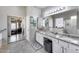 Bright bathroom with a double vanity, granite counters, a decorative window and a mirrored closet at 514 E Yvonne Ln, Tempe, AZ 85284