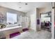 Bright bathroom featuring a glass-door shower, a soaking tub, and a double vanity sink at 514 E Yvonne Ln, Tempe, AZ 85284