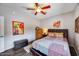 Bedroom features art on the wall, ceiling fan, and patterned bedding at 514 E Yvonne Ln, Tempe, AZ 85284