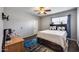 Bedroom with ceiling fan, wood-look flooring, and bright blue accent rug at 514 E Yvonne Ln, Tempe, AZ 85284