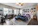 Bedroom features a ceiling fan, grey walls, and a workstation with natural light streaming in at 514 E Yvonne Ln, Tempe, AZ 85284