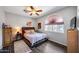Cozy bedroom with a ceiling fan, a large window, and an area rug on wood flooring at 514 E Yvonne Ln, Tempe, AZ 85284