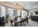 Bright dining area with a modern light fixture and views of the living area and backyard pool at 514 E Yvonne Ln, Tempe, AZ 85284