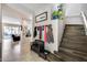 Bright entryway featuring a staircase, coat rack with seating, and views into living areas at 514 E Yvonne Ln, Tempe, AZ 85284