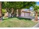 Charming two-story home with a tile roof, three-car garage, and lush landscaping with mature shade trees at 514 E Yvonne Ln, Tempe, AZ 85284