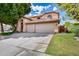 Inviting two-story home showcasing a tile roof, manicured lawn, mature trees, and a three-car garage at 514 E Yvonne Ln, Tempe, AZ 85284