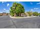 Street view of a charming home with lush trees, a well-manicured lawn, and an attached three-car garage at 514 E Yvonne Ln, Tempe, AZ 85284
