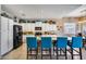 Stylish kitchen showcasing white cabinets, black appliances, granite countertops, and bar seating at 514 E Yvonne Ln, Tempe, AZ 85284