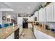 Modern kitchen featuring granite countertops, white cabinets and stainless steel appliances at 514 E Yvonne Ln, Tempe, AZ 85284