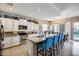 Bright eat-in kitchen featuring granite countertops, white cabinetry, stainless steel appliances, and a large island at 514 E Yvonne Ln, Tempe, AZ 85284