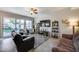 Comfortable living room with a ceiling fan, TV, tile flooring and sliding door access to the backyard at 514 E Yvonne Ln, Tempe, AZ 85284