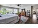 Spacious main bedroom featuring hardwood floors, ceiling fan, wooden furniture, and a large window at 514 E Yvonne Ln, Tempe, AZ 85284