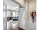 Home office space featuring a blue sofa, desk, and ample natural light, visible through an open doorway at 514 E Yvonne Ln, Tempe, AZ 85284