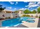 Beautiful pool and spa area with stone accents and mature landscaping at 514 E Yvonne Ln, Tempe, AZ 85284
