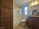 Bathroom featuring a shower with sliding glass doors and a wooden cabinet for linen storage at 650 N Hawes Rd # 4007, Mesa, AZ 85207