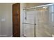 Bathroom featuring a shower with sliding glass doors and a wooden cabinet for linen storage at 650 N Hawes Rd # 4007, Mesa, AZ 85207