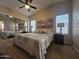 Relaxing bedroom features a ceiling fan, warm neutral walls, and a large mirrored closet at 650 N Hawes Rd # 4007, Mesa, AZ 85207