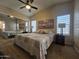 The bedroom features a bed, mirrored closet, windows, and bedside tables at 650 N Hawes Rd # 4007, Mesa, AZ 85207