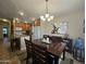 Inviting dining area with elegant chandelier, stylish artwork, and seamless flow to kitchen at 650 N Hawes Rd # 4007, Mesa, AZ 85207