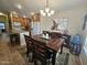 Cozy dining area featuring a wood table set for four, modern lighting, and seamless access to the kitchen at 650 N Hawes Rd # 4007, Mesa, AZ 85207