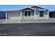 Exterior view of the home featuring a covered carport, porch, and well-maintained landscaping at 650 N Hawes Rd # 4007, Mesa, AZ 85207