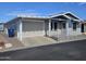 Charming single-Gathering home featuring a cozy porch, covered parking, and low-maintenance landscaping at 650 N Hawes Rd # 4007, Mesa, AZ 85207
