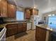 Functional kitchen featuring wood cabinetry, tile countertops, and appliances plus convenient access to the dining area at 650 N Hawes Rd # 4007, Mesa, AZ 85207