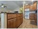 Spacious kitchen featuring wooden cabinets, granite countertop island, and tile floors at 650 N Hawes Rd # 4007, Mesa, AZ 85207