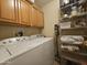 Laundry room featuring a washer, dryer, wood cabinets and wire storage shelves at 650 N Hawes Rd # 4007, Mesa, AZ 85207