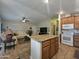 Open-concept living area with kitchen island, comfortable sofa, and modern finishes at 650 N Hawes Rd # 4007, Mesa, AZ 85207